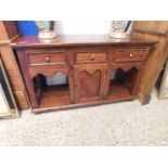 EASTERN HARDWOOD DRESSER BASE WITH THREE DRAWERS WITH CENTRAL CUPBOARD DOOR FLANKED EITHER SIDE BY