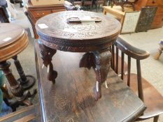 EASTERN HARDWOOD OCCASIONAL TABLE PROFUSELY CARVED THROUGHOUT SUPPORTED ON THREE HEAVILY CARVED