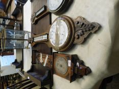 WALNUT CARVED BAROMETER WITH SILVERED DIAL TOGETHER WITH A FURTHER BAROMETER WITH CARVED OAK FRAME