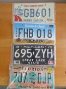 Four assorted decorative metal American Car Number Plates