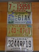 Four assorted decorative metal American Car Number Plates