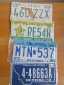 Four assorted decorative metal American Car Number Plates