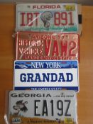 Four assorted decorative metal American Car Number Plates