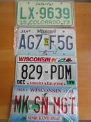 Four assorted decorative metal American Car Number Plates