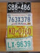 Four assorted decorative metal American Car Number Plates