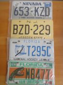 Four assorted decorative metal American Car Number Plates