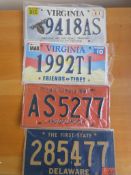 Four assorted decorative metal American Car Number Plates