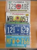 Four assorted decorative metal American Car Number Plates