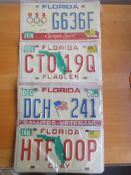 Four assorted decorative metal American Car Number Plates