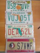 Four assorted decorative metal American Car Number Plates