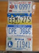 Four assorted decorative metal American Car Number Plates