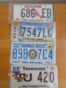 Four assorted decorative metal American Car Number Plates