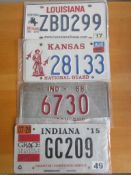 Four assorted decorative metal American Car Number Plates