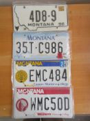 Four assorted decorative metal American Car Number Plates
