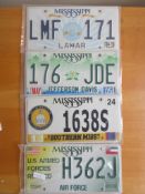 Four assorted decorative metal American Car Number Plates