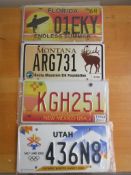 Four assorted decorative metal American Car Number Plates