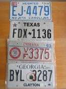 Four assorted decorative metal American Car Number Plates