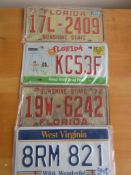 Four assorted decorative metal American Car Number Plates