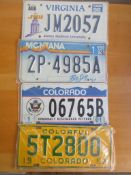 Four assorted decorative metal American Car Number Plates