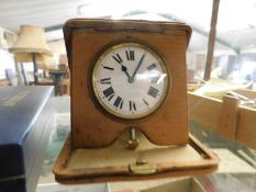 GOOD QUALITY TRAVEL CLOCK AND A FITTED LEATHER CASE WITH ENAMEL ARABIC CHAPTER RING