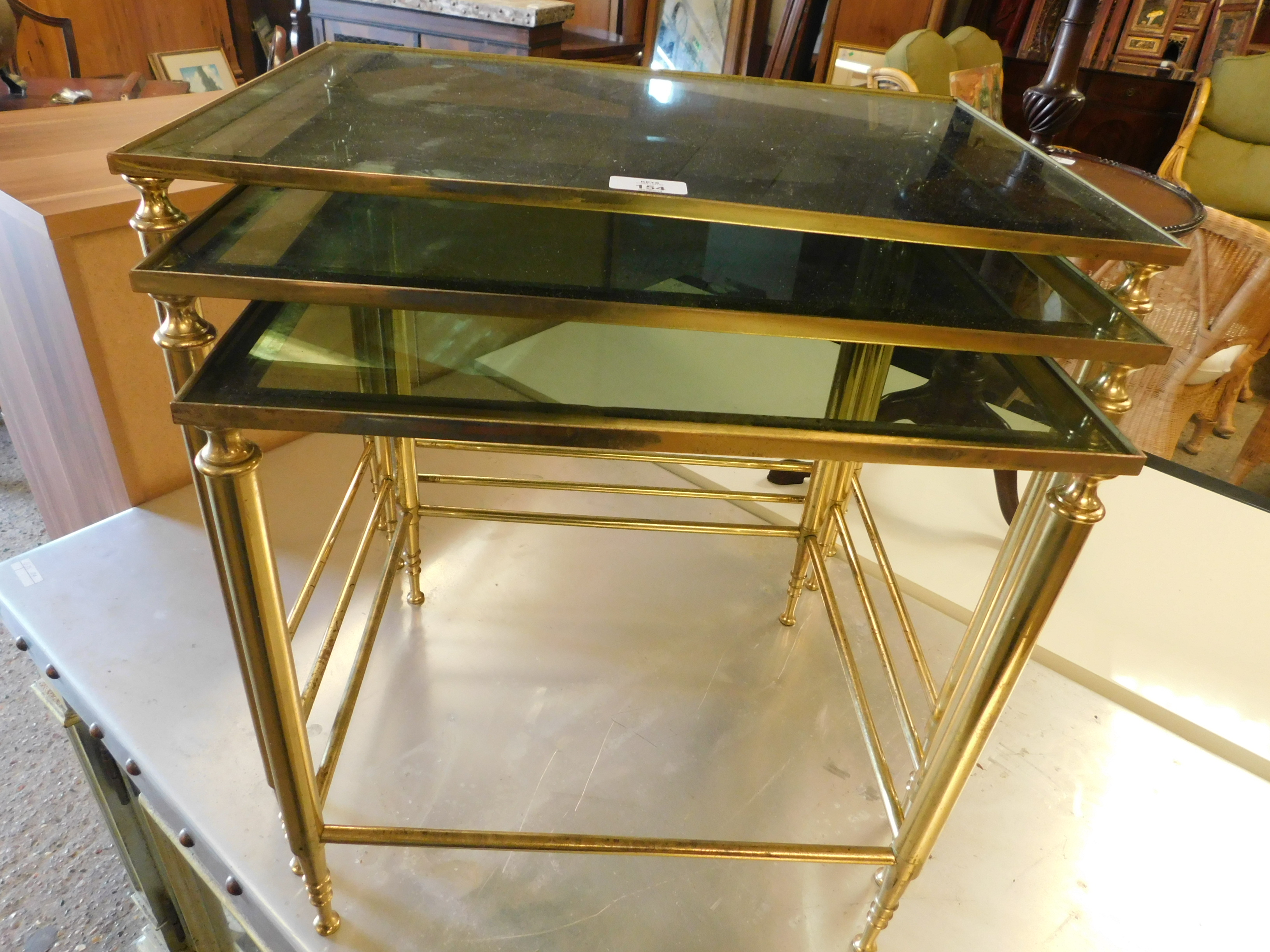 BRASS GLASS TOP SET OF THREE NESTING TABLES