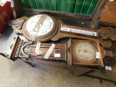 WALNUT CARVED BAROMETER WITH SILVERED DIAL TOGETHER WITH A FURTHER BAROMETER WITH CARVED OAK FRAME