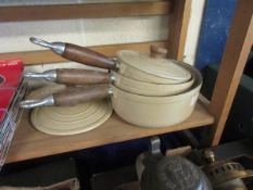 THREE FRENCH IRON AND ENAMEL SAUCEPANS AND LIDS
