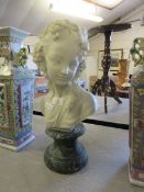 RESIN BUST OF A YOUNG GIRL ON A STYLISED MARBLE CIRCULAR PLINTH