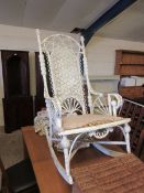 GOOD QUALITY WHITE PAINTED AND WICKER ROCKING CHAIR WITH PIERCED FLORAL BACK AND SHAPED ARMS WITH