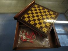 MAHOGANY CASED SLIDE TOP TRAVELLING CHESS SET WITH A QUANTITY OF STAINED BONE CHESS PIECES