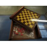 MAHOGANY CASED SLIDE TOP TRAVELLING CHESS SET WITH A QUANTITY OF STAINED BONE CHESS PIECES