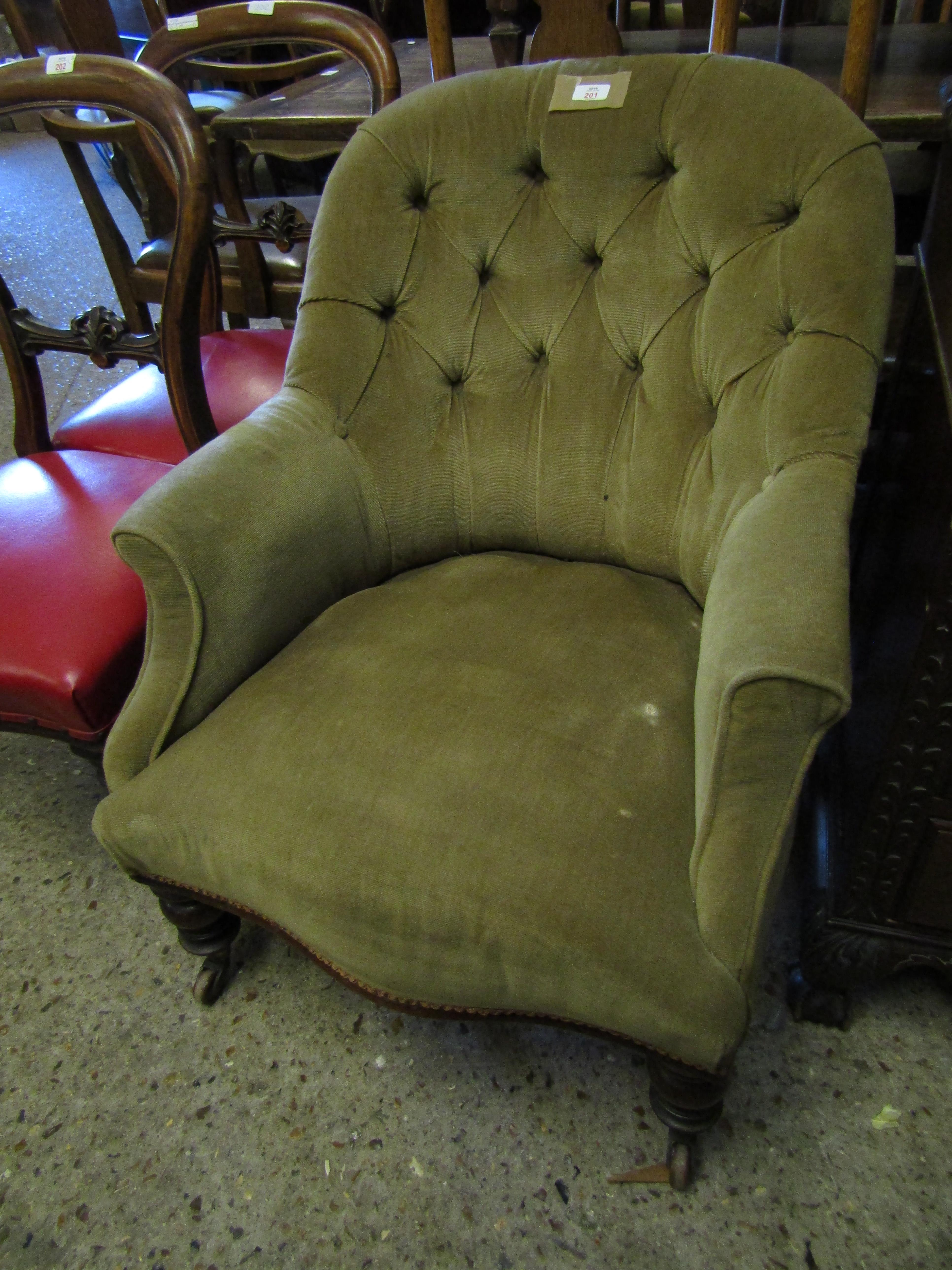 VICTORIAN MUSHROOM UPHOLSTERED BUTTON BACK ARMCHAIR WITH TURNED FRONT LEGS AND RAISED ON PORCELAIN