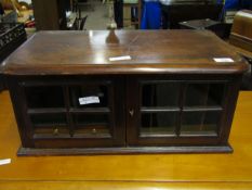 MAHOGANY FRAMED TABLE TOP COLLECTORS CABINET WITH TWO GLAZED DOORS AND SECTIONAL INSIDES