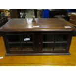 MAHOGANY FRAMED TABLE TOP COLLECTORS CABINET WITH TWO GLAZED DOORS AND SECTIONAL INSIDES