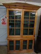 VICTORIAN WAX PINE BOOKCASE WITH PAGODA TOP AND FOUR GLAZED SECTIONAL DOORS