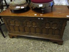 OAK FRAMED SMALL COFFER WITH DECORATIVE TOP ARCHED PANELLED FRONT RAISED ON SHAPED BRACKET FEET