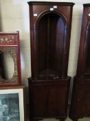 REPRODUCTION MAHOGANY CORNER CABINET WITH ARCHED TOP AND OPEN SHELVES OVER PANELLED DOOR