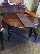 19TH CENTURY MAHOGANY CIRCULAR EXTENDING DINNING TABLE ON TURNED LEGS RAISED ON BRASS CASTORS