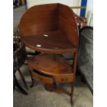 GEORGIAN MAHOGANY CORNER WASH STAND FITTED WITH TWO OPEN SHELVES AND SINGLE DRAWER ON A SPLAYED BASE