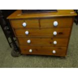 VICTORIAN STAINED PINE TWO OVER THREE FULL WIDTH DRAWER CHEST WITH WHITE PORCELAIN HANDLES RAISED ON