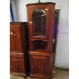 STAINED PINE FLOOR STANDING CORNER CUPBOARD WITH GLAZED DOOR, OPEN SHELF AND PANELLED CUPBOARD