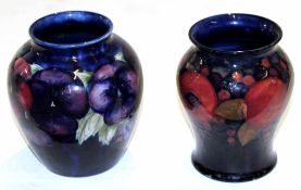 Two Moorcroft mid-20th century vases, one with tube lined pomegranate pattern and Moorcroft