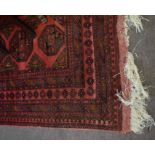 Good quality large Bokhara type carpet with repeating lozenge centre in a red field with multi-