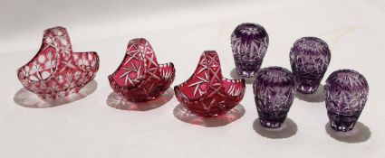 Group of Bohemian style cut glass vases with purple colouring and three small baskets, all cut