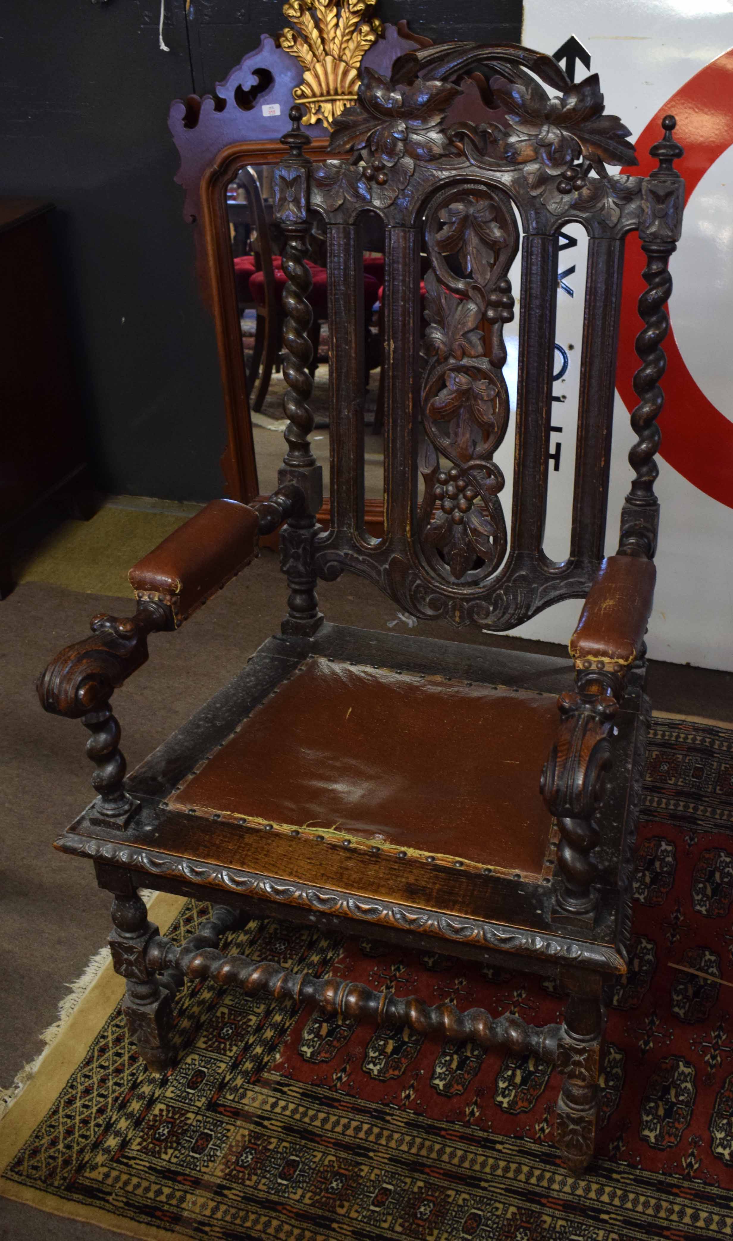 Large Victorian oak elbow chair with barley twist supports and stretchers, carved grapevine