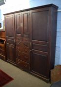 Early 19th century oak housekeeper's cupboard of large proportions, fitted centrally with two