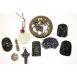 Group of Oriental carved metal and stone tablets, the largest 8cm diam (8)