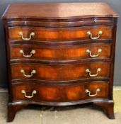 Reproduction mahogany serpentine front bachelor's chest with brushing slide over four drawers with