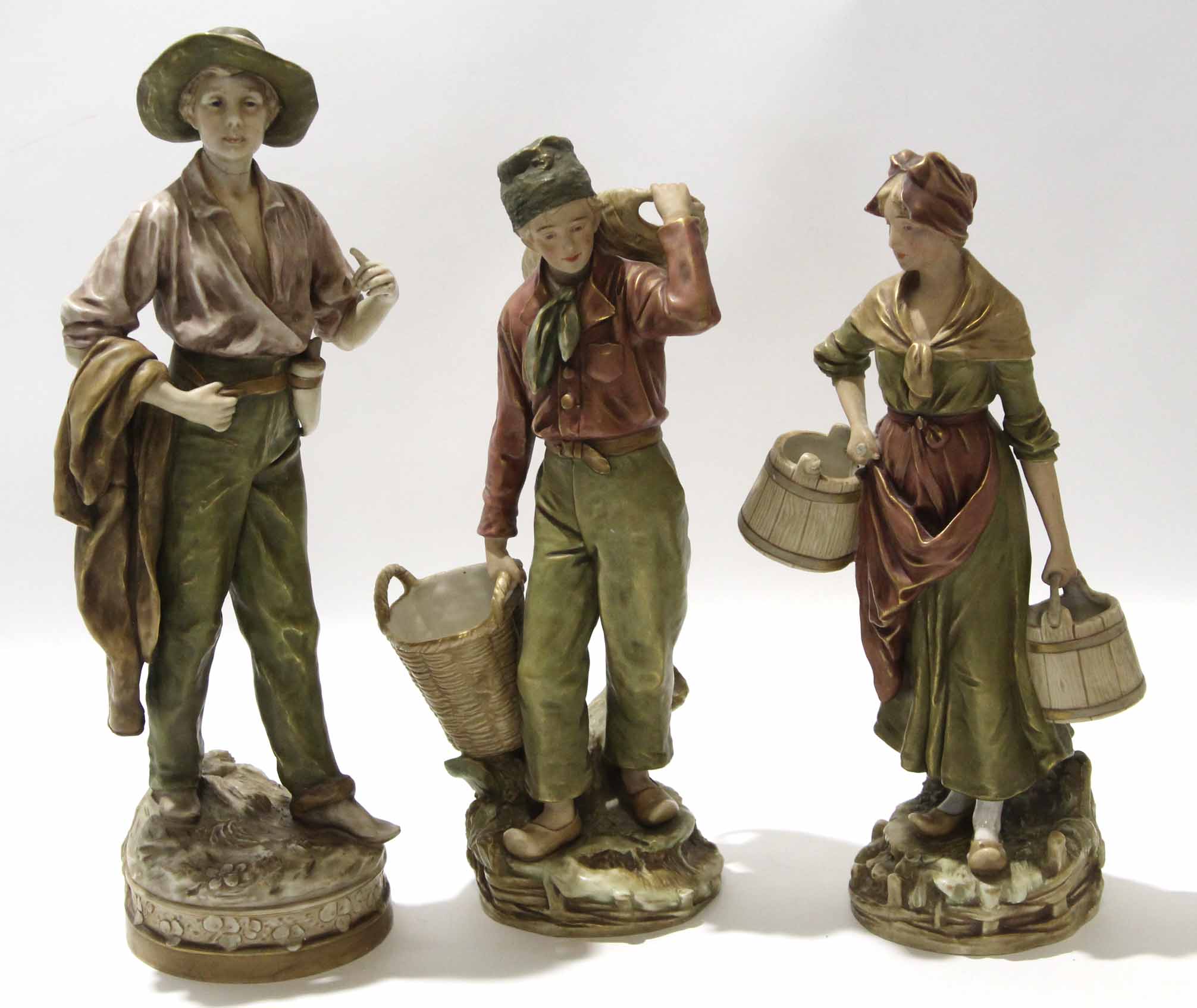 Group of three Royal Dux Bohemia wares, one modelled as a dandy, the other two as a girl carrying