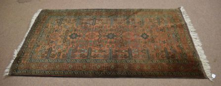 Good quality modern carpet with brown and green field with geometric design, 117cm wide x 215cm